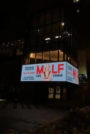 MILF Life Crisis on a lit-up theatre marquee at night
